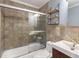 Bathroom featuring tiled shower and tub with sliding glass doors, and modern floating shelves at 115 Biscayne Nw Dr # E3, Atlanta, GA 30309