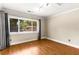 Bedroom featuring hardwood floors, large window and neutral color palette at 115 Biscayne Nw Dr # E3, Atlanta, GA 30309