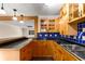 Kitchen with bar and blue backsplash featuring wood cabinets and stainless steel sink at 115 Biscayne Nw Dr # E3, Atlanta, GA 30309
