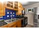 Kitchen area featuring black appliances, double sink, with glass tile backsplash at 115 Biscayne Nw Dr # E3, Atlanta, GA 30309