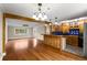 Open-concept kitchen featuring hardwood floors and a breakfast bar with natural wood beam at 115 Biscayne Nw Dr # E3, Atlanta, GA 30309
