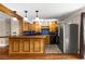 Open kitchen featuring a breakfast bar, pendant lighting and stainless steel refrigerator at 115 Biscayne Nw Dr # E3, Atlanta, GA 30309
