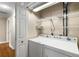 Bright laundry room with washer, dryer, and shelving for extra storage at 115 Biscayne Nw Dr # E3, Atlanta, GA 30309