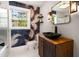 Chic bathroom with a vessel sink, striking wallpaper, unique lighting, and natural light from a large window at 345 Adelle Se St, Atlanta, GA 30315