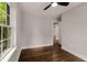 Bright bedroom featuring hardwood floors, natural light from the window, and neutral gray walls at 345 Adelle Se St, Atlanta, GA 30315