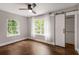 Bedroom with hardwood floors, natural light, a ceiling fan, and a modern sliding barn door closet at 345 Adelle Se St, Atlanta, GA 30315