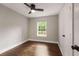Bright bedroom with a dark ceiling fan and a large window letting in natural light at 345 Adelle Se St, Atlanta, GA 30315