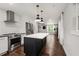 Bright kitchen boasts stainless steel appliances, a large island, and an open concept design leading into the living area at 345 Adelle Se St, Atlanta, GA 30315