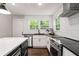 Modern kitchen with stainless appliances, granite counters, stylish backsplash, and a large center island perfect for entertaining at 345 Adelle Se St, Atlanta, GA 30315
