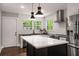 Bright kitchen features white subway tile, stainless steel appliances, and a large center island with quartz countertop at 345 Adelle Se St, Atlanta, GA 30315