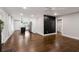 Open-concept living area featuring hardwood floors, a modern accent wall, and seamless access to the kitchen at 345 Adelle Se St, Atlanta, GA 30315