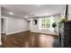 Inviting living space showcasing hardwood floors, a fireplace, and a large window with sheer curtains at 345 Adelle Se St, Atlanta, GA 30315