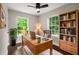 Comfortable home office with hardwood floors, two windows, desk, chair, and built-in bookcase at 345 Adelle Se St, Atlanta, GA 30315