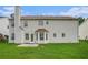 Back exterior with a lush lawn, patio area, and an overall view of the property at 555 Sydney Crest Ln, Lawrenceville, GA 30046