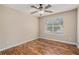 Cozy bedroom featuring hardwood floors, natural light, and a ceiling fan at 555 Sydney Crest Ln, Lawrenceville, GA 30046