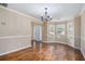 Elegant dining room with hardwood floors, chandelier, and a bay window letting in natural light at 555 Sydney Crest Ln, Lawrenceville, GA 30046