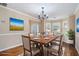 Elegant dining room with a wood table, chandelier lighting, and large windows for a bright and welcoming space at 555 Sydney Crest Ln, Lawrenceville, GA 30046