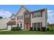 Charming two-story home featuring a two-car garage and a well-manicured lawn with traditional design elements at 555 Sydney Crest Ln, Lawrenceville, GA 30046
