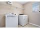 Functional laundry room equipped with a washer, dryer, and overhead shelving at 555 Sydney Crest Ln, Lawrenceville, GA 30046