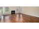 Cozy living room with a fireplace, hardwood floors, and large windows that flood the space with natural light at 555 Sydney Crest Ln, Lawrenceville, GA 30046