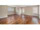 Open-concept living room with hardwood floors and ample natural light, creating a welcoming space at 555 Sydney Crest Ln, Lawrenceville, GA 30046
