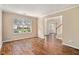 Bright living room with hardwood floors and large windows, offering an open view of the surrounding neighborhood at 555 Sydney Crest Ln, Lawrenceville, GA 30046