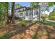 Back exterior with a deck and many windows at 7115 Doncaster Ct, Cumming, GA 30040