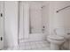 Bathroom featuring a tub and shower combination with white tile, along with a toilet at 7115 Doncaster Ct, Cumming, GA 30040