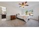 Bedroom with carpet, a ceiling fan, and a window with a view of the outdoors at 7115 Doncaster Ct, Cumming, GA 30040