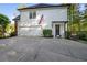 Traditional home featuring an attached garage, manicured lawn and a covered front entrance at 7115 Doncaster Ct, Cumming, GA 30040
