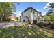 Traditional two-story home features a long driveway, attached garage and a wooden deck at 7115 Doncaster Ct, Cumming, GA 30040