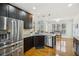 Gourmet kitchen featuring stainless steel appliances and a center island with a breakfast bar at 7115 Doncaster Ct, Cumming, GA 30040