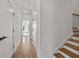 Hallway with hardwood floors, white doors, and an adjacent staircase with white risers at 1836 Memorial Dr # 303, Atlanta, GA 30317