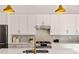 Beautiful white kitchen with stainless steel appliances, white countertops, and a gold faucet at 1836 Memorial Dr # 303, Atlanta, GA 30317