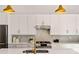 Modern kitchen with white cabinets, stainless steel appliances, and gold accents at 1836 Memorial Dr # 303, Atlanta, GA 30317