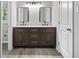 Bathroom featuring double vanity with marble countertops and dark wood cabinetry at 2487 Highland Se Dr, Conyers, GA 30013
