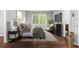 Bedroom with hardwood floors, neutral walls, large bed, and modern furniture at 2487 Highland Se Dr, Conyers, GA 30013