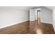 Hardwood floors in this carpet-free bedroom space featuring neutral walls and an open doorway to another room at 2487 Highland Se Dr, Conyers, GA 30013