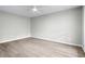 Large, empty bedroom with wood-look floors, a ceiling fan, and gray walls at 2487 Highland Se Dr, Conyers, GA 30013