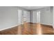 Large bedroom with hardwood floors and multiple doorways leading to other rooms at 2487 Highland Se Dr, Conyers, GA 30013