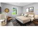 Cozy bedroom with a wooden headboard, neutral bedding, and bright window overlooking the lawn at 2487 Highland Se Dr, Conyers, GA 30013