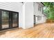 Large wooden deck featuring black framed glass doors and white siding at 2487 Highland Se Dr, Conyers, GA 30013