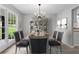 Formal dining area featuring modern decor, a dining table set for six, and ample natural light at 2487 Highland Se Dr, Conyers, GA 30013