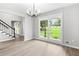 Light-filled dining room with hardwood floors, a chandelier and large windows offering backyard views at 2487 Highland Se Dr, Conyers, GA 30013