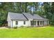 Attractive home featuring an attached garage, manicured lawn, classic shutters and welcoming front porch at 2487 Highland Se Dr, Conyers, GA 30013