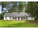 Charming single-story home with a well-maintained lawn, black shutters, and an inviting front porch at 2487 Highland Se Dr, Conyers, GA 30013