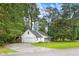 Single-story home with a well-maintained lawn, attached garage and a long driveway at 2487 Highland Se Dr, Conyers, GA 30013