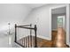 Hallway with hardwood floors, white trim, and a view of other rooms at 2487 Highland Se Dr, Conyers, GA 30013