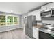 Spacious kitchen with stainless steel appliances and large windows overlooking yard at 2487 Highland Se Dr, Conyers, GA 30013
