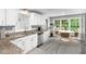 Well-lit kitchen with granite countertops and a cozy dining area at 2487 Highland Se Dr, Conyers, GA 30013